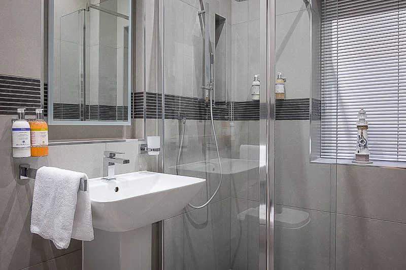 Shower enclosure and basin in Seagrass Apartment