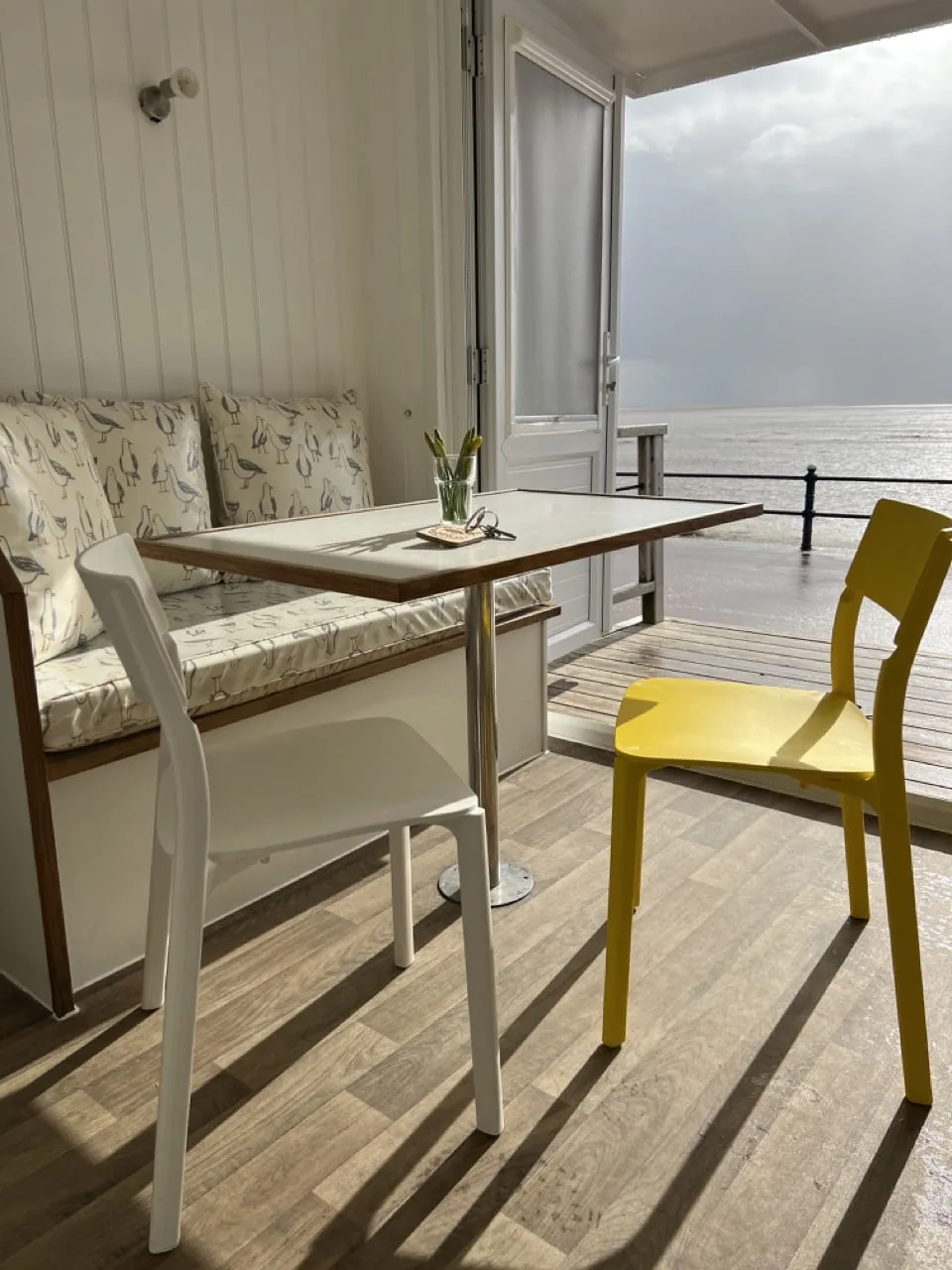 View towards the sea from inside a beach hut