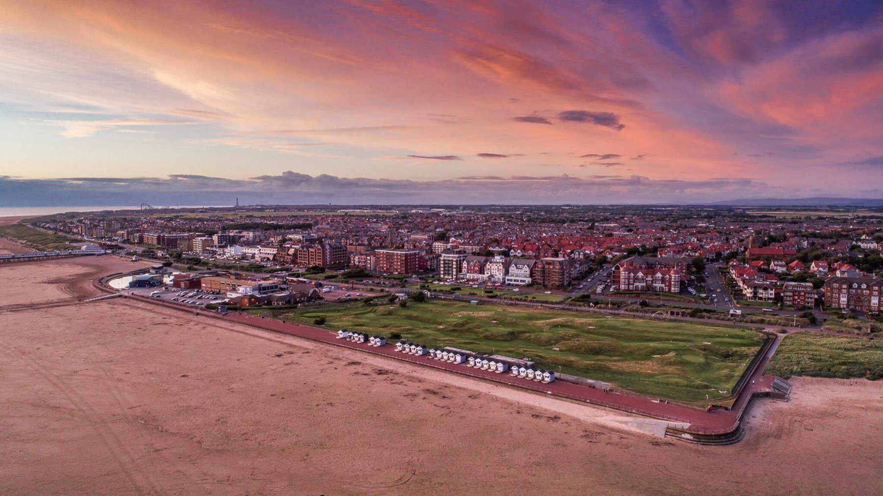 Aerial view of the Beach Huts, beach and St Annes seafront at sunset