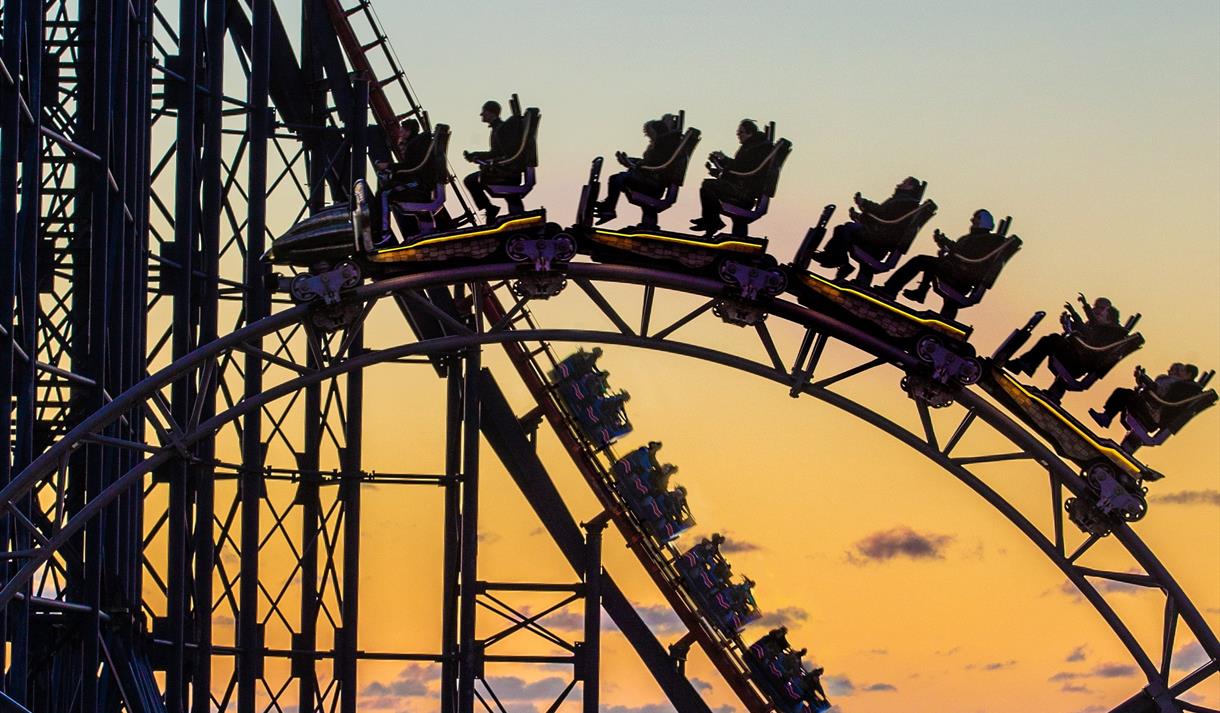 A rollercoaster silhouetted against the sunset